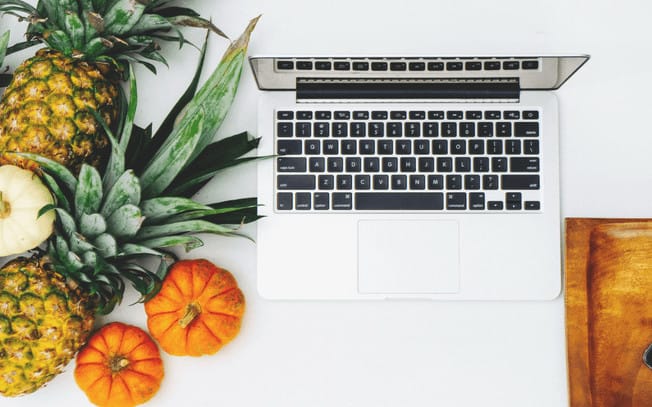 Ariel view of computer with pumpkins beside it