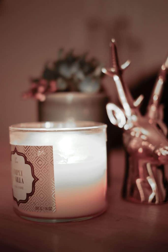 Candle on a table with an ornament beside it