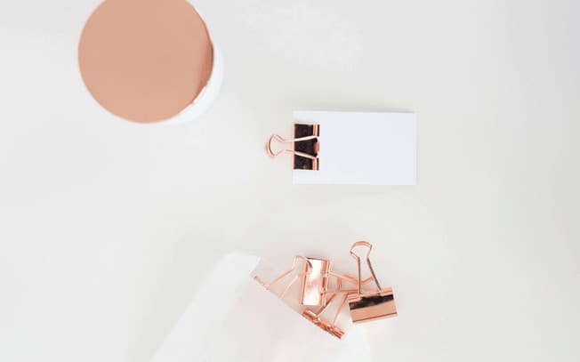 Rose gold paper clips and paper