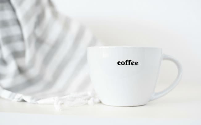 a cup that says "coffee"