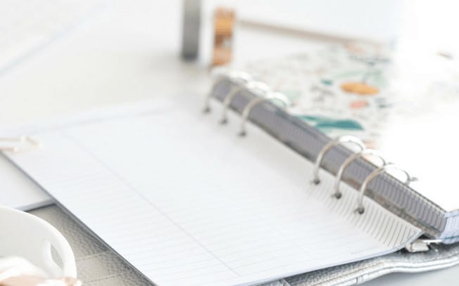 A notebook with empty pages on a desk