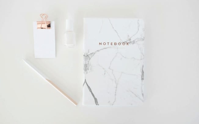 Styled photo of notebook, pencil, nailpolish and notepad