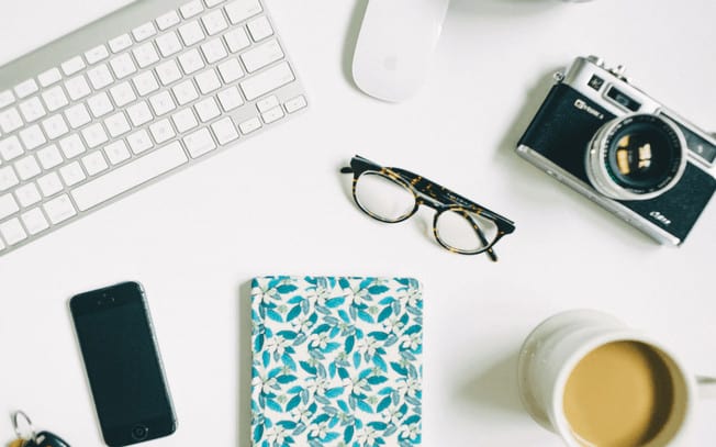 Styled photo with tea, camera, laptop, notebook, iphone and glasses