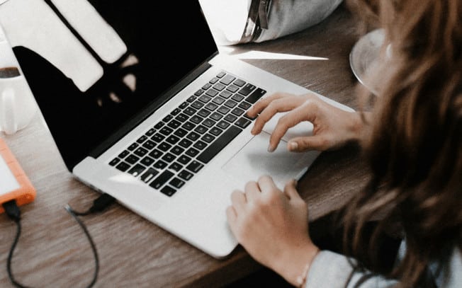 Girl typing on her laptop