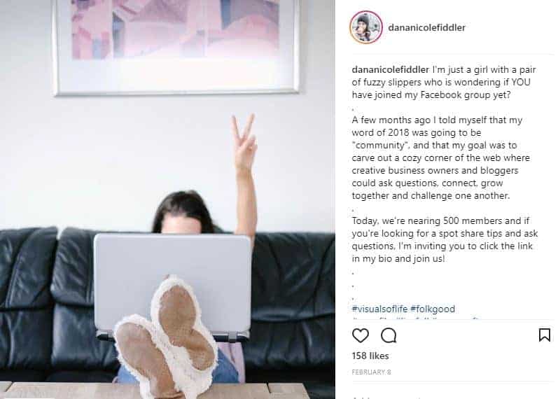 Screenshot of an Instagram post of a girl working on her laptop, giving the peace sign