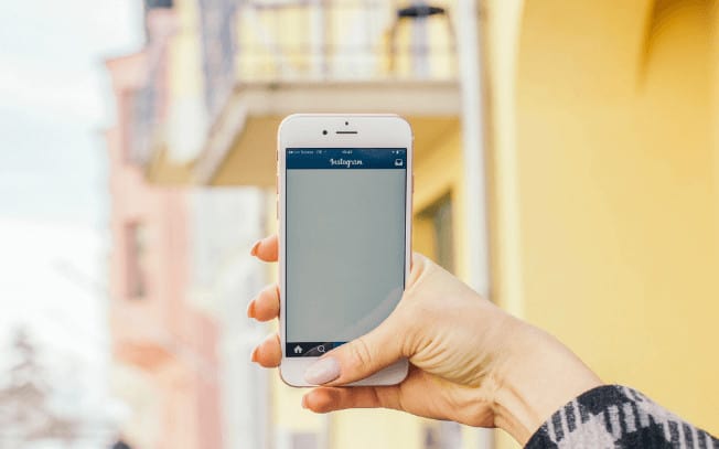 Person holding an iPhone outside