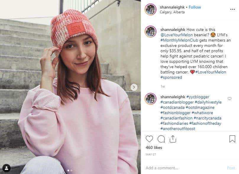 Instagram post of a girl in a pink sweater wearing a tye dye toque