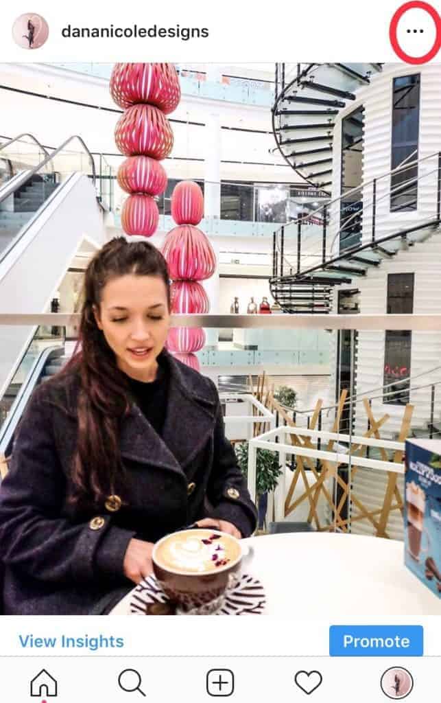 Girl sitting in a mall with a cup of coffee