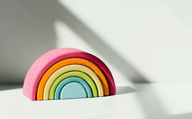 A rainbow toy on a white desk