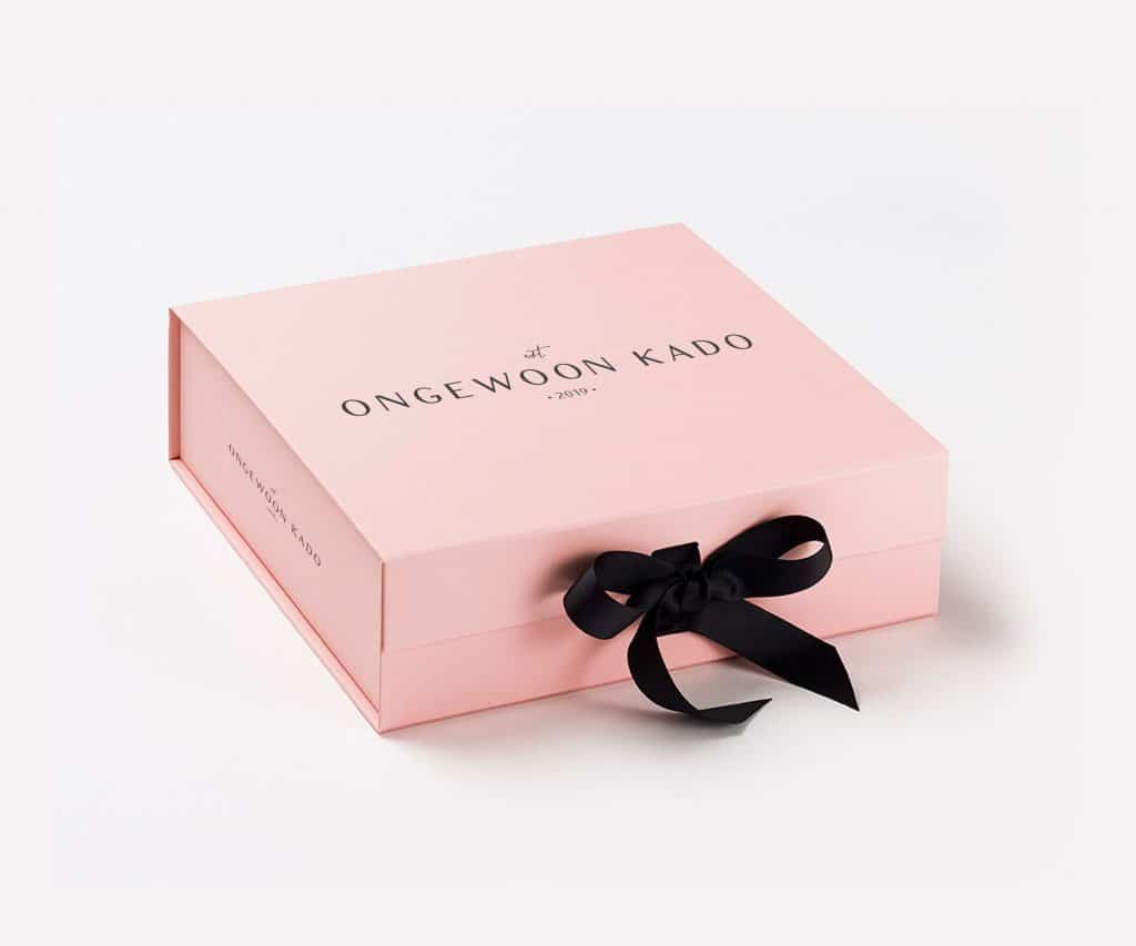 A pink box with a black bow