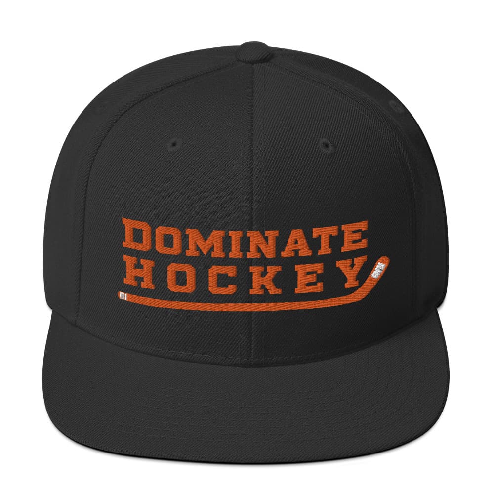 a black hat with orange writing that says "dominate hockey"