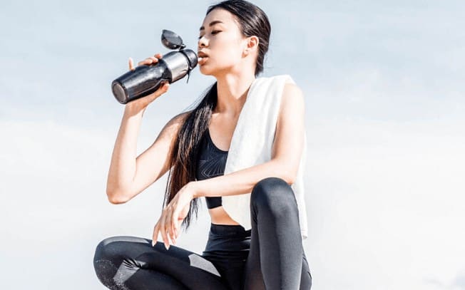 Woman drinking water after working out