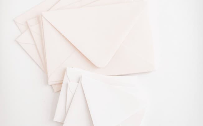 Pink envelopes on a white surface