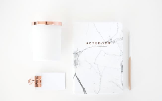 Marble patterned notebook styled alongside notepad