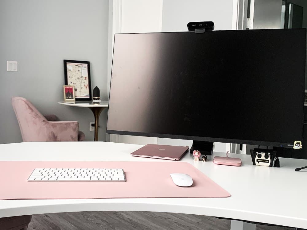 A desk with a large computer.